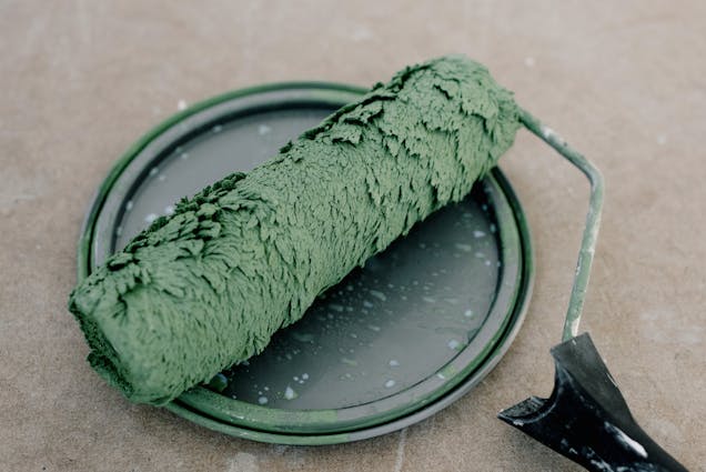 a%20green%20paint%20roller%20resting%20on%20a%20paint%20can%20lid a%20green%20paint%20roller%20resting%20on%20a%20paint%20can%20lid